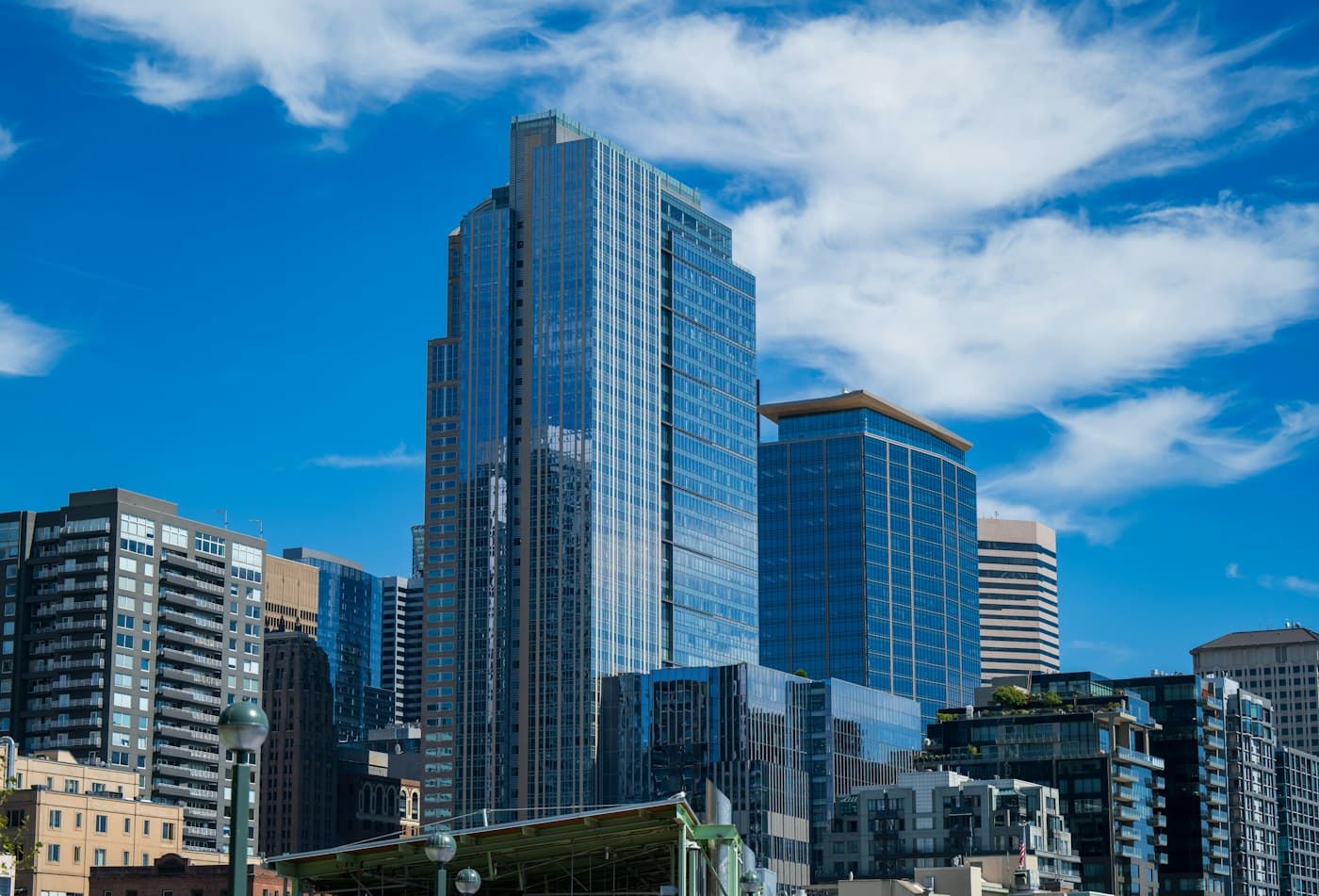 Glass office towers rising against a clear blue sky